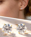 Hypoallergenic Titanium Screw Back Earrings Set Three Pairs VVS1 Sparkling Moissanite Studs worn on ear with pastel background