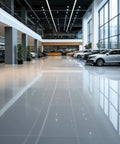 Kick Ass Heavy Duty Low Foam Auto Floor Cleaner Industrial Strength Concentrate used on a shiny polished concrete car showroom floor.