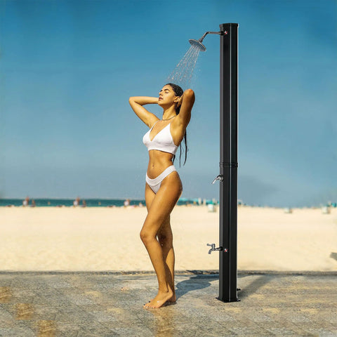 7Ft Outdoor Solar Heated Shower With 360 Degree Rotating Head, Foot Shower Faucet, Temperature And Pressure Control, Freestanding 9.2 Gallon Tank For Backyard Pool And Garden in use at the beach