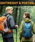 Hikers with orange and blue backpacks holding trekking poles on a forest trail