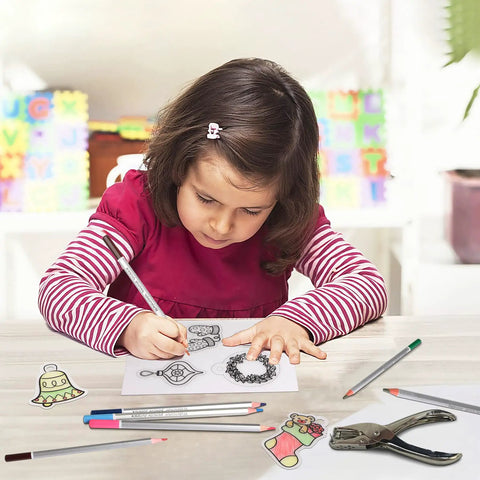 Child using colored pencils on heat shrink creations, part of Kickstart Your Craft Game With This Hella Cool 198 Piece Heat Shrink Plastic Sheet Kit.