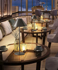 Modern LED Rechargeable Cordless Table Lamp With Dimmable Eye Protection Light on a glass table in a cozy lounge setting