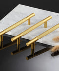 Three gold knurled cabinet handles on white marble, not 10 Pack Black Knurled Cabinet Handles 7 Inch Pulls with 5 Inch Center, Matte Black Drawer Handles.