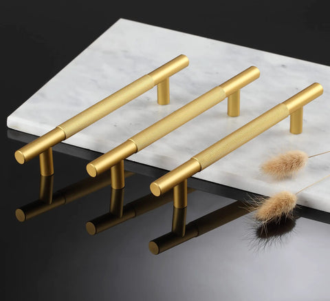 Three gold knurled cabinet handles on white marble, not 10 Pack Black Knurled Cabinet Handles 7 Inch Pulls with 5 Inch Center, Matte Black Drawer Handles.