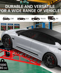 Heavy Duty 11,000 Lbs Hydraulic Car Ramps With Low Profile Lift, red ramp under a silver car in garage setting