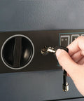 Person unlocking Digital Drop Safe Money Drop Box With Front Deposit Slot, Steel Security Safe With LED Keypad, Wall Or Floor Mount, Compact Black Safe For Home And Small Biz, 0.54 Cubic Feet with key