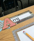 Home Sweet Classroom Flat Name Plates 36 Pack For Labels Centers And Storage Eleven And A Half By Three And A Half Inches Durable Laminatable Name Tags For Student Names And Substitutes displayed on a wooden desk.