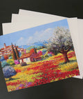 Colorful village landscape printed on 100 Percent Printable Cotton Canvas Sheets For Inkjet Printers, Matte White 8.5 By 11 Inches, 17 Mil Thick, Pack Of 10, Totally Real Fabric Printing With High Resolution Ink, Tear Resistant DIY Craft Canvas For Inkjet Projects, shown on black background.