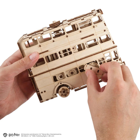 Knight Bus 3D Puzzle With 268 Pieces And 7.7 Inch Build Size Transformable Triple Decker Design, Spring Powered Motor, Flip Gear Coasting, Pre Laser Cut Wood Panels And No Glue Needed For Quick Hands On Fun. Hands assembling wooden 3D bus model
