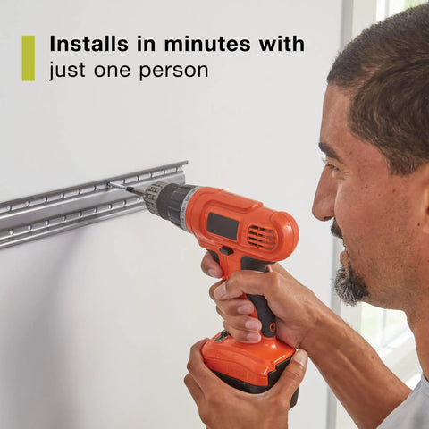 Person installing FastTrack Garage Wall Mounted Storage Kit With Four Rails And Eleven Hooks For Home Workshop Sports Equipment