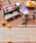 2600W Portable Gas Stove With Cassette Design And Multi Stage Adjustable Flame For Camping And Outdoor Travel Butane Stove With Storage Case Easy To Carry For Picnics Milk White, displayed on wooden table with oranges and tomatoes.