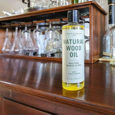 Natural Wood Conditioning Oil With Coconut Oil For Natural Furniture Care Orange Scent 8 Oz bottle on wooden cabinet