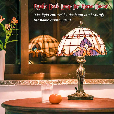 Vintage Tiffany Style Glass Table Lamp With Eye Catching Shade for bedside, on a wooden table with decorative base and stained glass.