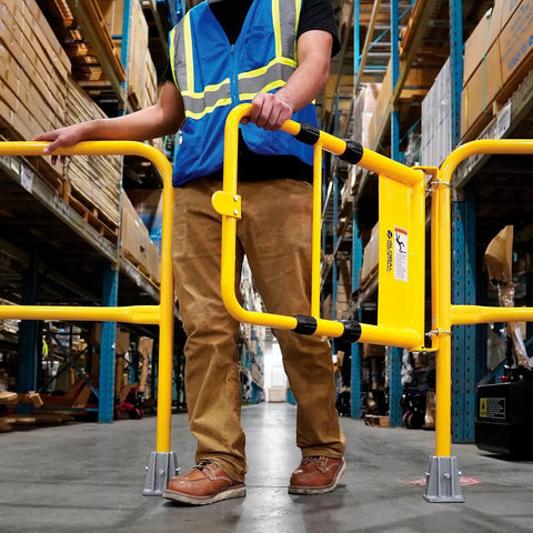 Person operating Straight Up Adjustable Spring Loaded Safety Swing Gate In High Visibility Yellow Steel on job site.