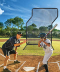 Coach and player using Baseball Z Screen Heavy Duty 7x5ft Portable Pitching Screen in a sunny field for batting practice.