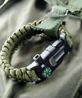 5 In 1 Paracord Survival Bracelet with Compass Fire Starter Whistle Glass Breaker and Paracord on green backpack
