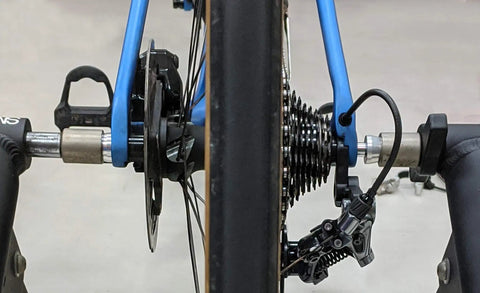Bicycle set up with Through Axle Trainer 147 for Roaddisc Rear Wheel Set With M12 1.0 1.5 1.75 Variants in garage