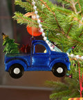 Blue Vintage Iron Christmas Truck Ornament For Christmas Tree, Rustic Farmhouse Style Hangable Pendant Decor, Small Vintage Pickup Ornament Hauling A Festive Tree Dope Holiday Decor hanging on a Christmas tree.