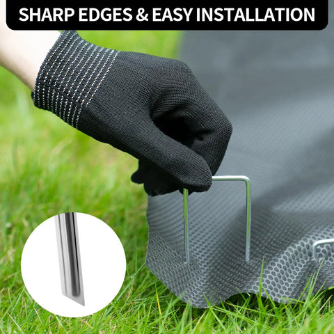 Gloved hand installing Heavy Duty 6 Inch U-Shaped Landscape Staples Set, 120 Pack, 11 Gauge Galvanized Steel Garden Stakes for sod and weed barrier.