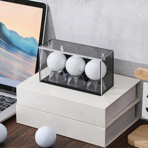 Baseball And Golf Ball Display Case For Three Balls With UV Protected Acrylic Box Memorabilia Showcase For Autographs And Cube Displays Black Finish 5.9 By 2.4 By 1.8 Inches on desk with golf balls nearby