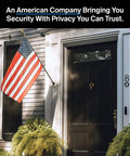 Front view of a house with an American flag displayed next to a door fitted with a 2K Video Doorbell With Wired Or Wireless Setup.