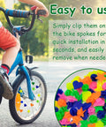 Child's bike with 180 Pieces Colorful Bike Wheel Spoke Beads Clips, demonstrating easy installation and assorted bright colors.