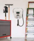 Badass Level 2 EV Charger Hard Wired With 30 Amp 240 Volt J1772 Compatibility mounted on garage wall near tools and ladder.