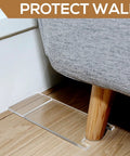 Slick Clear Couch Wall Spacers And Furniture Stoppers To Shield Your Sofa Bed From Scratches While Taming Messy Cords And Keeping Your Living Room Fresh With Zero Drama Setup placed under a couch leg to protect the wall.