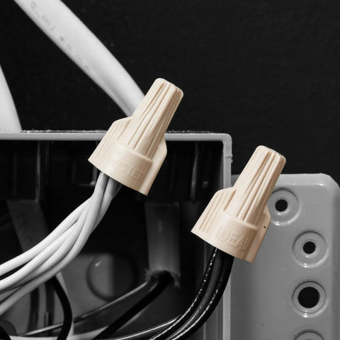 Tan Twist On Wire Connectors Box Of One Hundred For 22 To 8 AWG Electrical Lines With Ribbed Grip Caps and High Leverage Wings close-up.