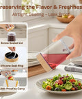 4 Pack 10oz Glass Meal Prep Jars with Bamboo Lids being used for pouring dressing over salad