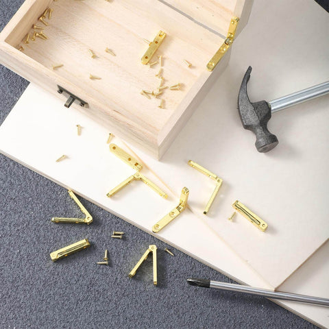 Gold Zinc Alloy Jewelry Box Hinges Set, 10 Pcs 90 Degree Small Hinges With 40 Screws on table next to wooden box and hammer