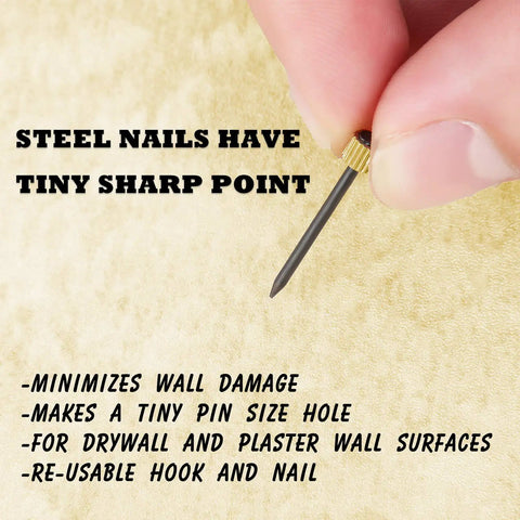 Close-up of a hand holding a nail from 100 Pieces Picture Hanging Nails Set 0.16 x 0.98 Inch Wall Hanger Nails For Drywall Holds 5-30 Lbs