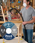 Man using stationary HVLP finishing sprayer for woodworkers wanting killer results on furniture restoration projects.