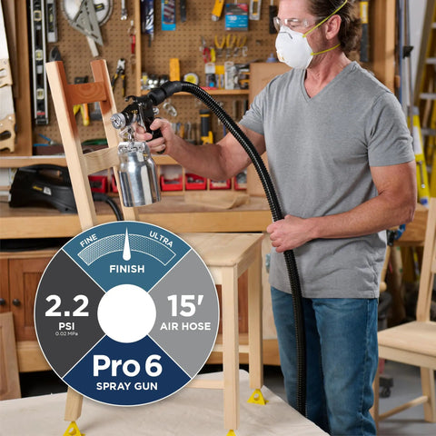 Man using stationary HVLP finishing sprayer for woodworkers wanting killer results on furniture restoration projects.