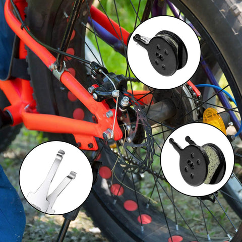 4 Pairs Resin Disc Brake Pads For Mechanical Bike Brakes Compatible With Avid BB5 CSC Kingdom Promax DC Series And More Low Noise Low Dust Disc Friendly High Temp Performance Long Lasting And Easy Install displayed next to a bicycle wheel and brake system.