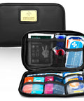 Black Everlit Care car first aid kit in zippered case; opened view shows mesh pockets and assorted medical supplies.