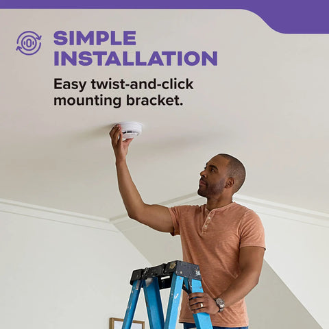 Person installing Smoke And Carbon Monoxide Detector Hardwired With Ten Year Battery Backup Interconnected 85 Decibel Alarm LED Status Lights 5 Inch Sensor Unit 30CUA10 3 Pack Home Safety Must Have on ceiling.
