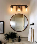 Bathroom with Rustic Faux Wood Three Light Farmhouse Vanity Light With Clear Glass Shades Distressed Black Backing And Decorative Panels Perfect Bathroom Fixture For Warm Ambience Simple Modern Farmhouse Style Upgrade