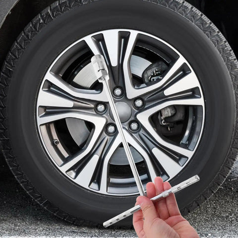 Rock Solid T Handle Socket Wrench Set With Slick Non Slip Grip And Bombproof Steel Build For Smooth Machine Fastener Work And Everyday Garage Swaps For Real Pros held next to a vehicle wheel.