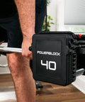 Pro 100 Straight Bar For Adjustable Dumbbell System in use during a weightlifting exercise, demonstrating home gym versatility.