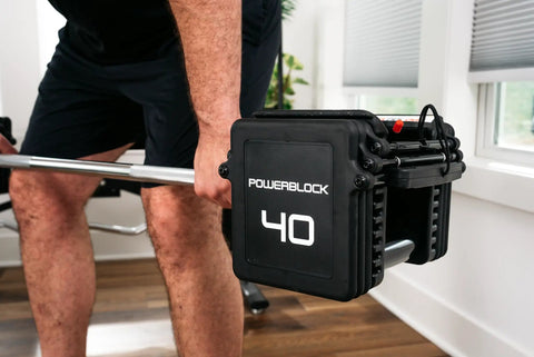 Pro 100 Straight Bar For Adjustable Dumbbell System in use during a weightlifting exercise, demonstrating home gym versatility.