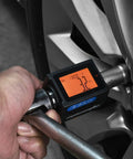 One Half Inch Digital Torque Adapter With Beep Alert Garage Ready in use on vehicle wheel, showing digital display.