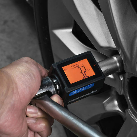 One Half Inch Digital Torque Adapter With Beep Alert Garage Ready in use on vehicle wheel, showing digital display.