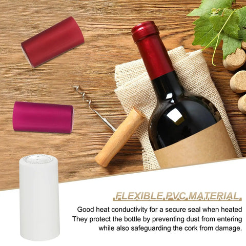 White PVC Heat Shrink Caps 120 Pack Wine Bottle Neck Covers with red and pink caps on a wooden table.