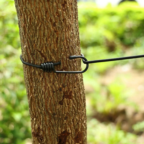 Super Portable Retractable Clothesline For Travel And Camping On The Go tied to a tree showing outdoor setup.