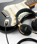 Dope Tone Wired Smart Guitar Headphone Amp with Custom Audio Drivers shown connected to an electric guitar with cable.