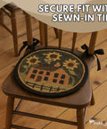 Round Chair Pad Featuring House And Sunflowers Folk Art Design Totally Sweet Seat Cushion with sewn-in ties on a wooden chair.