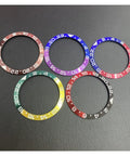 Various colored ceramic bezel inserts for 43mm Sea-Dweller GMT watch, including brown, for DIY repairs and upgrades on black surface.