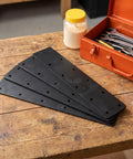 Heavy Duty Stainless Steel Flat Brace Bracket Set 4 Pieces on a wooden table with tools beside them