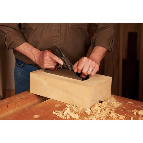 Pro Grade Number Four Bench Plane Built Like A Tank For Intense Shop Sessions Smooths Rough Boards Effortlessly being used on wood block.